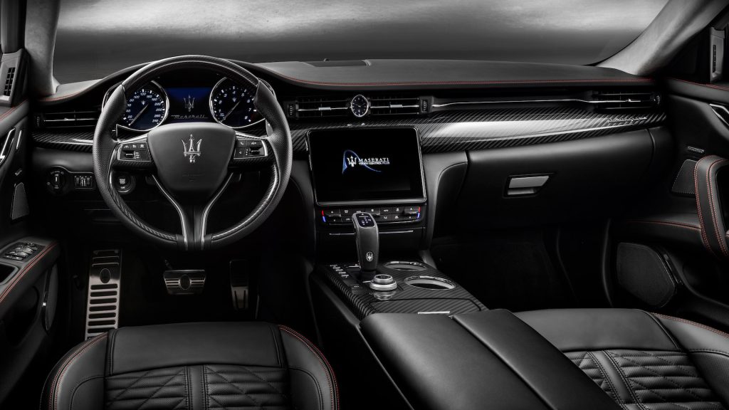 Luxury Maserati interior with touchscreen display, leather seats, and advanced safety features like airbags and driver assistance systems.